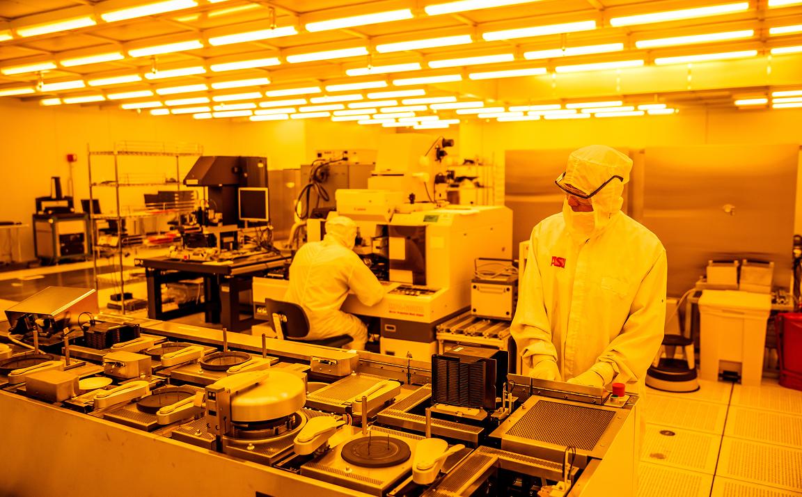 People in bunny suits work in the cleanroom at ASU's MacroTechnology Works facility